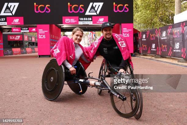 Catherine Debrunner of Switzerland and Marcel Hug of Switzerland celebrate after winning the Women's and Men's Elite Wheelchair Race respectively...