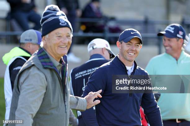 Rory McIlroy of Northern Ireland reacts after shaking hands with Bill Murray, the American Film Actor, on the tee box on the 1st hole on Day Four of...
