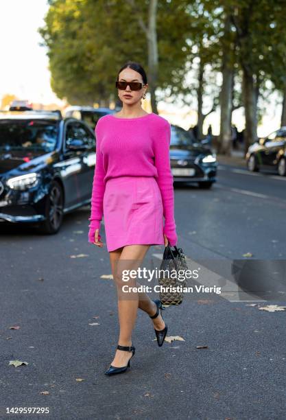 Karina Bik wears pink skirt, jumper, Prada bag, heels outside Akris during Paris Fashion Week - Womenswear Spring/Summer 2023 : Day Six on October...