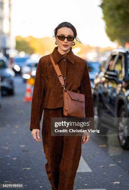 Mary Leest wears brown bag, corduroy jacket, pants, sunglasses outside Akris during Paris Fashion Week - Womenswear Spring/Summer 2023 : Day Six on...