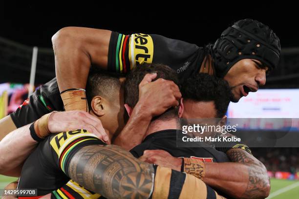 Dylan Edwards of the Panthers celebrates with team mates Apisai Koroisau and Stephen Crichton of the Panthers during the 2022 NRL Grand Final match...