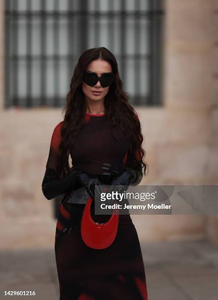 Sabina Jakubowicz seen wearing a Loewe dress with a bag by Coperni, Balenciaga sunglasses and shoes by Yves Saint Laurent, outside Loewe during Paris...