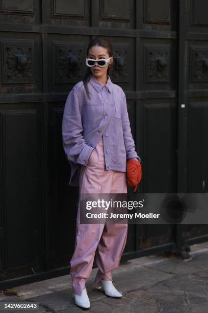 Jenny Tsang seen wearing white Loewe sunglasses and a Loewe bag, outside Loewe during Paris Fashion Week on September 30, 2022 in Paris, France.