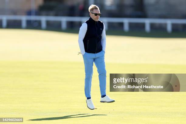 Ronan Keating leaps in the air as they make their way down the fairway on the 1st hole on Day Four of the Alfred Dunhill Links Championship on the...