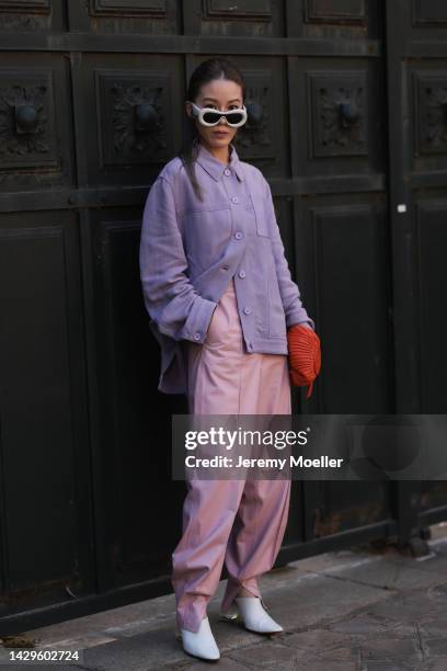 Jenny Tsang seen wearing white Loewe sunglasses and a Loewe bag, outside Loewe during Paris Fashion Week on September 30, 2022 in Paris, France.