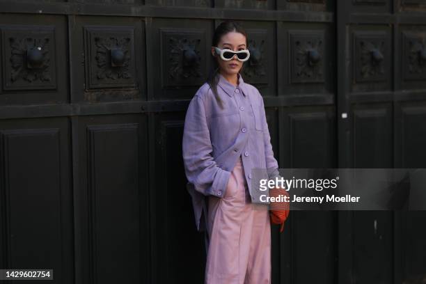 Jenny Tsang seen wearing white Loewe sunglasses and a Loewe bag, outside Loewe during Paris Fashion Week on September 30, 2022 in Paris, France.