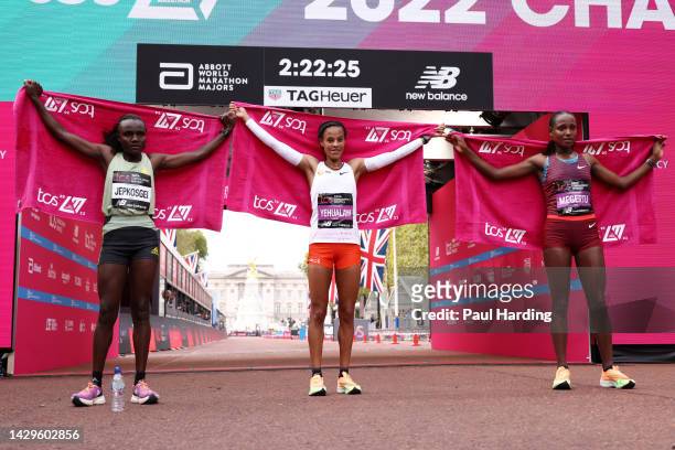 Second placed Joyciline Jepkosgei of Kenya, first placed Yalemzerf Yehualaw of Ethiopia and third placed Alemu Megertu of Ethiopia pose for a photo...