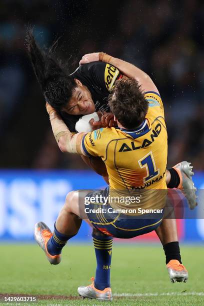 Brian To'o of the Panthers is tackled by Clinton Gutherson of the Eels during the 2022 NRL Grand Final match between the Penrith Panthers and the...