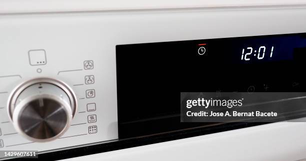 buttons and control panel  oven with the clock timer flashing. - cooker dial stock pictures, royalty-free photos & images