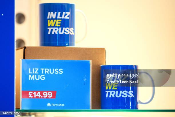 In Liz We Truss" promotional mugs are seen on a souvenir stall, on day one of the Conservative Party Conference on October 02, 2022 in Birmingham,...