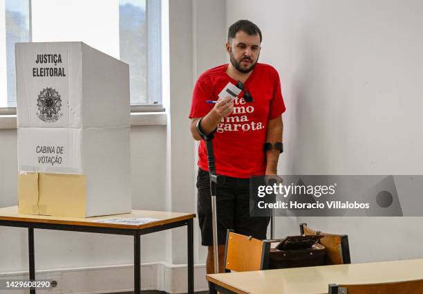 Brazilian resident in Portugal walks aided by canes to put his vote in the ballot box at Room 16 of the polling station in Law School of Lisbon...