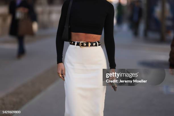 Cassandra Dimicco seen wearing a black croptop and a long white skirt with black plateau leather boots, outside Loewe during Paris Fashion Week on...