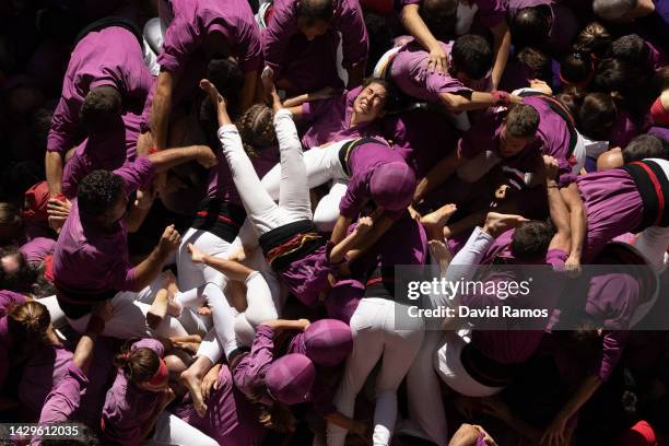 Members of the colla 'Moixiganguers of Igualada' fall down as they build a human tower during the 28th Tarragona Competition on October 2, 2022 in...