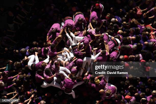 Members of the colla 'Moixiganguers of Igualada' fall down ad they build a human tower during the 28th Tarragona Competition on October 2, 2022 in...