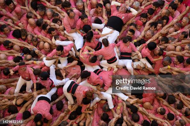 Members of the colla 'Colla Vella Xiquets de Valls' fall down as they build a human tower during the 28th Tarragona Competition on October 2, 2022 in...