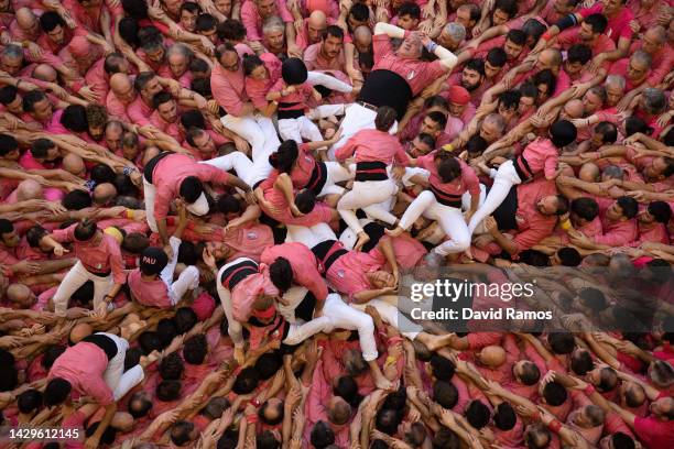 Members of the colla 'Colla Vella Xiquets de Valls' fall down as they build a human tower during the 28th Tarragona Competition on October 2, 2022 in...