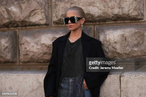 Caro Daur seen wearing a total Loewe look, outside Loewe during Paris Fashion Week on September 30, 2022 in Paris, France.
