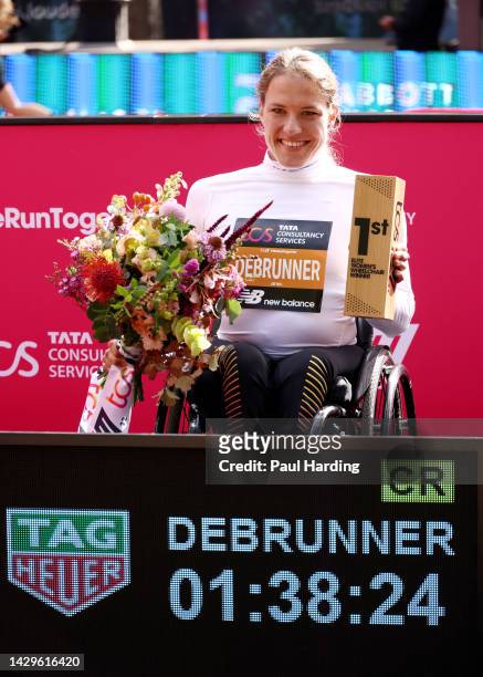 First placed Catherine Debrunner of Switzerland poses for a photo with their trophy after the Elite Women's Wheelchair Marathon during the 2022 TCS...