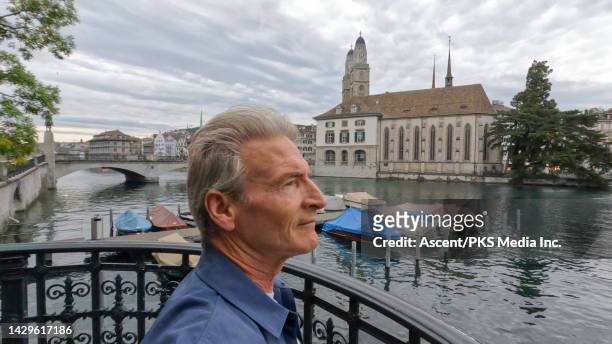 side profile of mature man exploring old town and canals - in profile stock pictures, royalty-free photos & images