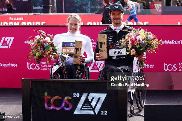 Catherine Debrunner of Switzerland and Marcel Hug of Switzerland celebrate with their trophies after winning the Women's and Men's Elite Wheelchair...