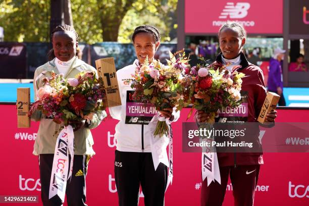 Second placed Joyciline Jepkosgei of Kenya, first placed Yalemzerf Yehualaw of Ethiopia and third placed Alemu Megertu of Ethiopia pose for a photo...