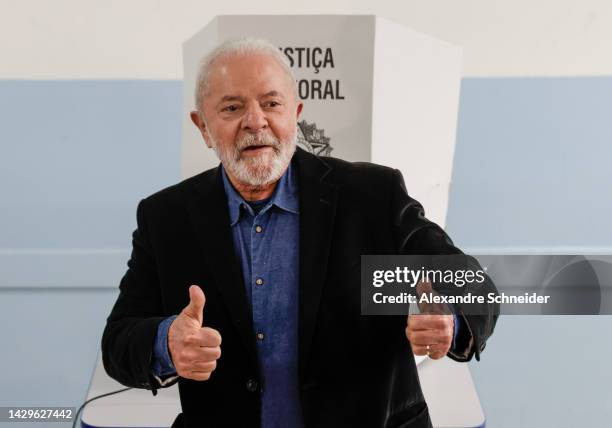 Former president of Brazil and Candidate of Worker's Party Luiz Inacio Lula da Silva gestures to the journalists after voting during general...