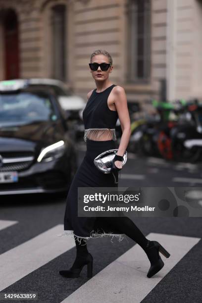 Tamaraah Al Gabaani wearing a two-piece by Stoud and a ByFar silver bag on September 29, 2022 in Paris, France.