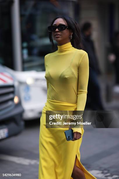 Guest seen wearing black square sunglasses, gold earrings, a yellow turtleneck long sleeves top, a matching yellow slit long skirt, outside Gauchere,...