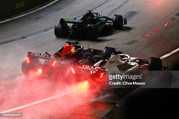 Max Verstappen of the Netherlands driving the Oracle Red Bull Racing RB18 and Kevin Magnussen of Denmark driving the Haas F1 VF-22 Ferrari battle for...