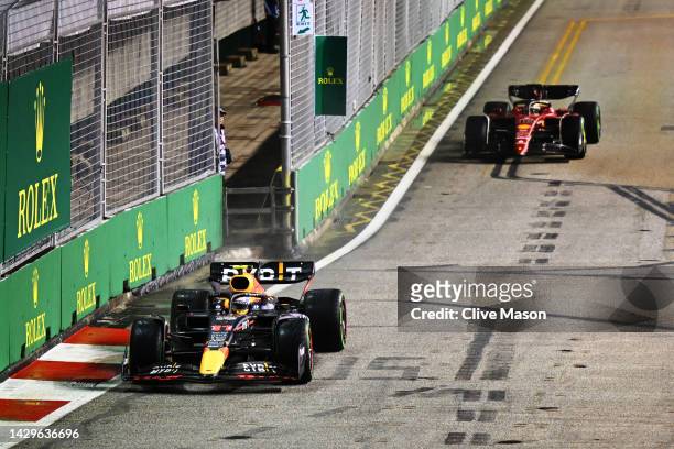 Sergio Perez of Mexico driving the Oracle Red Bull Racing RB18 leads Charles Leclerc of Monaco driving the Ferrari F1-75 on lap one during the F1...