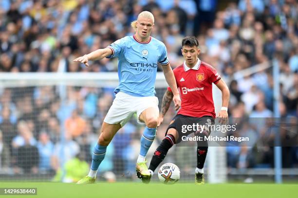 Erling Haaland of Manchester City battles for possession with Lisandro Martinez of Manchester United during the Premier League match between...