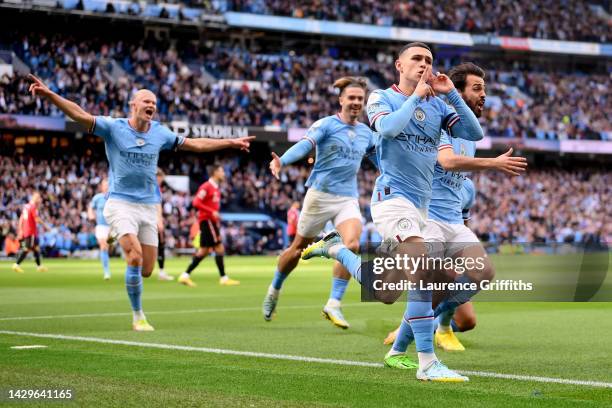 Phil Foden of Manchester City celebrates their sides first goal during the Premier League match between Manchester City and Manchester United at...