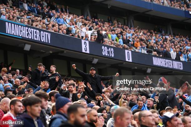 Fans of Manchester City celebrate as Erling Haaland of Manchester City scores their sides third goal during the Premier League match between...