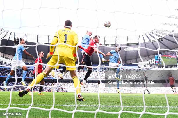 Erling Haaland of Manchester City scores their sides second goal past David De Gea of Manchester United during the Premier League match between...