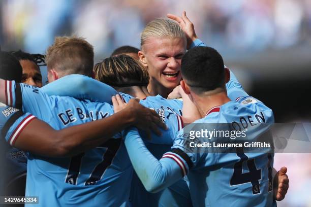 Erling Haaland of Manchester City celebrates their sides second goal with team mate Phil Foden during the Premier League match between Manchester...