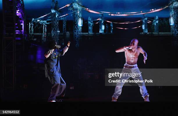 Rapper Snoop Dogg and a hologram of deceased Tupac Shakur perform onstage during day 3 of the 2012 Coachella Valley Music & Arts Festival at the...