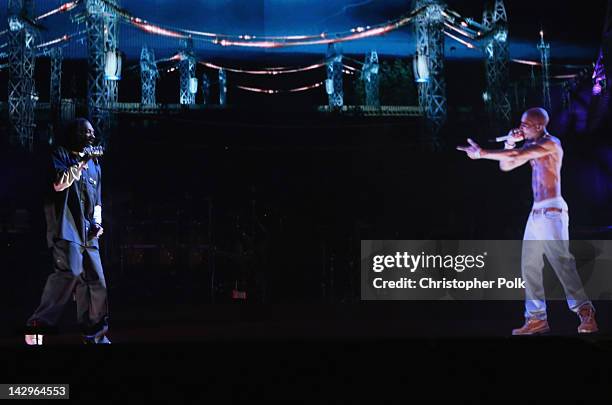 Rapper Snoop Dogg and a hologram of deceased Tupac Shakur perform onstage during day 3 of the 2012 Coachella Valley Music & Arts Festival at the...