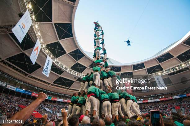 Members of the casteller 'Tres de deu amb folre i manilles' of the 'Castellers de Vilafranca' form a castell in a contest in the bullring 'Tarraco...