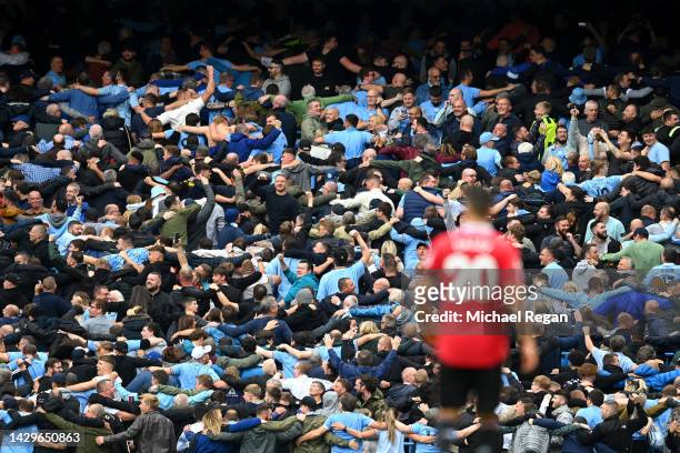 Fans of Manchester City dance the Poznan as they celebrate as Erling Haaland of Manchester City scores their sides fifth goal during the Premier...