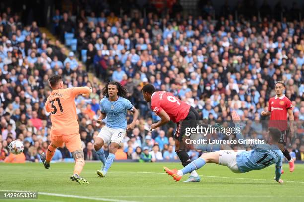 Anthony Martial of Manchester United scores their sides second goal past Ederson of Manchester City whilst under pressure from Aymeric Laporte of...