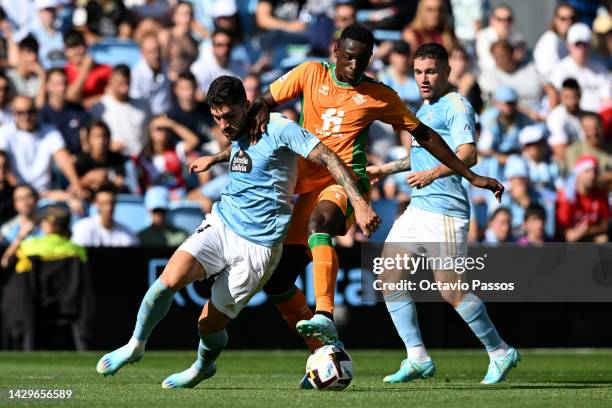 Unai Nunez of Celta Vigo is challenged by Luiz Henrique of Real Betis during the LaLiga Santander match between RC Celta and Real Betis at Estadio...