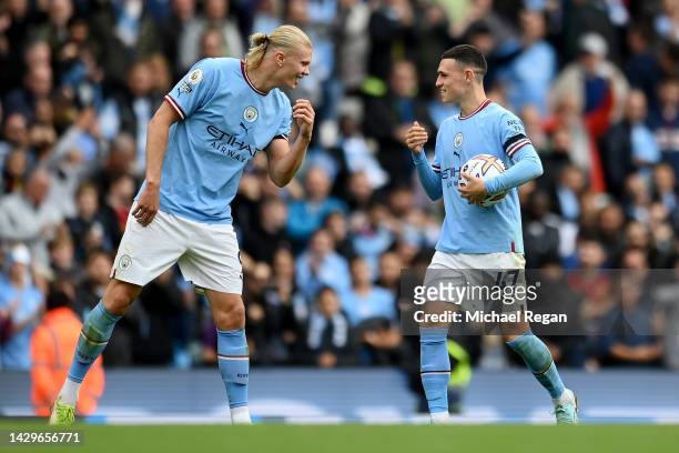 Erling Haaland and Phil Foden of Manchester City interact following the Premier League match between Manchester City and Manchester United at Etihad...