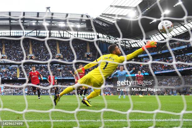 Phil Foden of Manchester City scores their sides sixth goal and their hat trick past David De Gea of Manchester United during the Premier League...