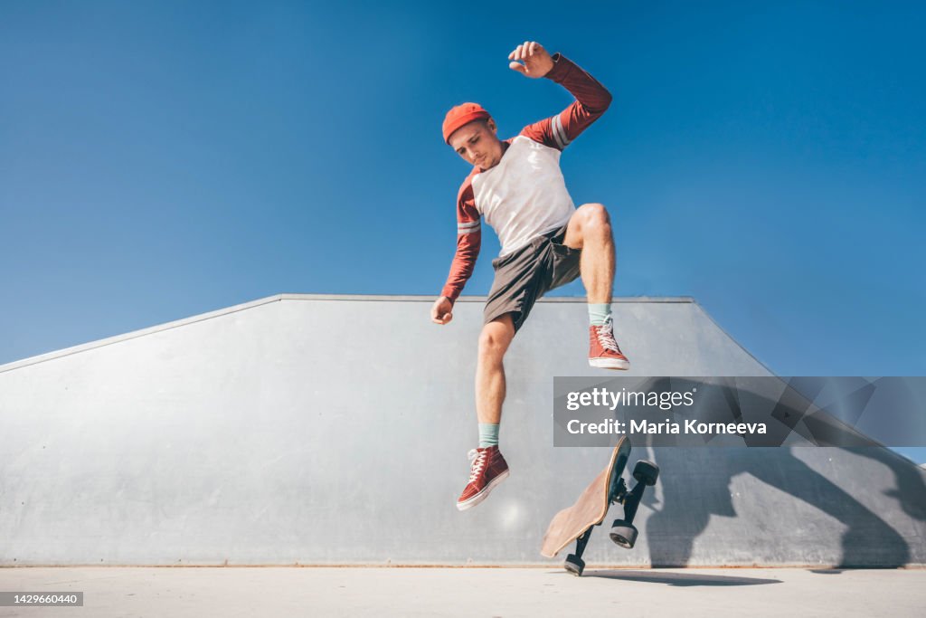 Skateboarder jumping at a skate park.