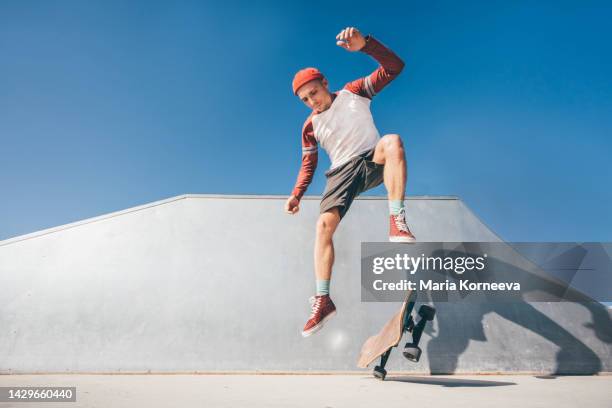 skateboarder jumping at a skate park. - skate stock-fotos und bilder