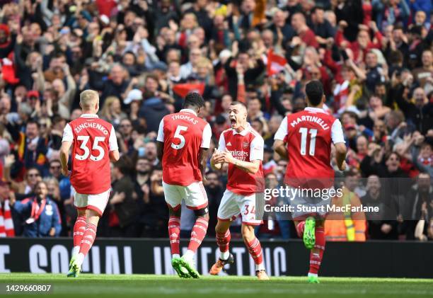 Thomas Partey celebrates scoring the 1st Arsenal goal with Granit Xhaka during the Premier League match between Arsenal FC and Tottenham Hotspur at...