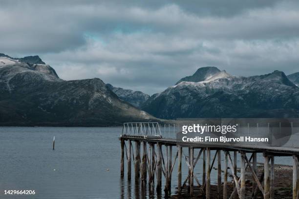 pier in a norwegian fjord near tromsø in northern norway - finn bjurvoll stock pictures, royalty-free photos & images