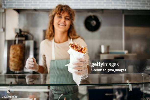 woman works in a fast food shop - doner kebab fast food stock pictures, royalty-free photos & images