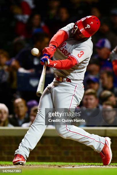 Bryce Harper of the Philadelphia Phillies hits a RBI sacrifice fly in the third inning against the Chicago Cubs at Wrigley Field on September 28,...