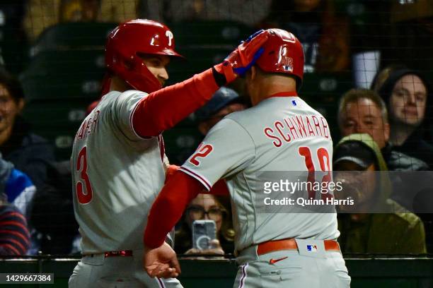 Bryce Harper and Kyle Schwarber of the Philadelphia Phillies celebrate after scoring in the third inning against the Chicago Cubs at Wrigley Field on...